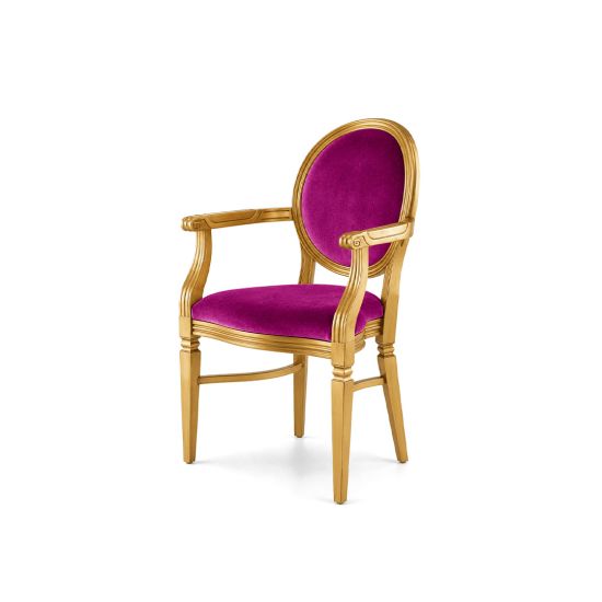 Chandelle luxury armchair with a polished gold frame and vivid magenta velvet.