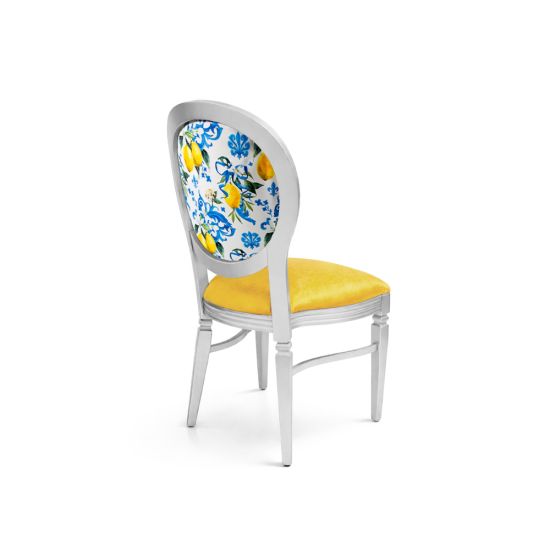 Silver Chandelle chair with oval floral back in blue and yellow tones and yellow upholstered seat, elegant vintage-style banquet chair for weddings and formal events
