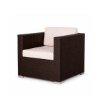 Mocha rattan armchair with woven frame and white cushion, modern outdoor lounge chair rental for weddings and events.