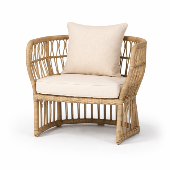 Bohemian rattan lounge chair with woven frame and white cushion, natural wicker seating rental for boho weddings and events.