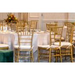 Gold resin Chiavari chair with black cushion seat, spindled high back and slim four-leg frame, elegant event seating