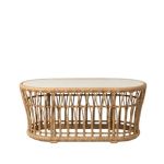 Oval rattan coffee table with open-weave frame and smooth top, offering a relaxed coastal and bohemian aesthetic for lounge settings