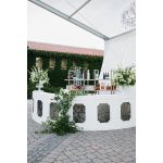 White curved Colonial Rattan event rental bar with silver stainless-steel insert panel for luxury event cocktail stations