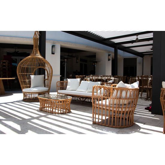 Oval rattan coffee table with open-weave frame and smooth top, offering a relaxed coastal and bohemian aesthetic for lounge settings