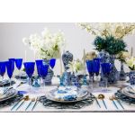 Saint Louis cobalt blue champagne goblet with clear stem and base, elegant colored event glassware for weddings and toasts.
