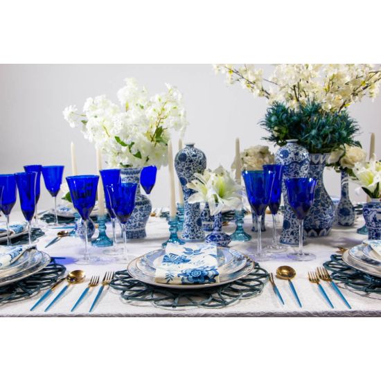 Saint Louis cobalt blue champagne goblet with clear stem and base, elegant colored event glassware for weddings and toasts.