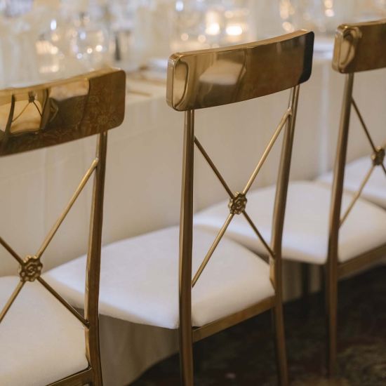 Gold Athena event dining chair with White velvet seat cushion and matching backrest