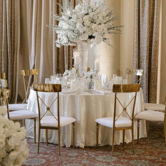 Gold Athena event dining chair with White velvet seat cushion and matching backrest