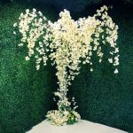 Artificial cherry blossom tree with cascading white blooms on a trunk base, elegant floral décor for weddings, stages, and event backdrops.