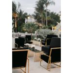 Black velvet lounge armchair with polished gold metal frame and open square base, modern luxury seating for upscale event lounges.