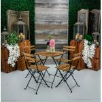 Rustic bistro table with square wood top and black folding metal legs, cocktail table rental for outdoor events and rustic weddings.