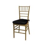 Gold resin Chiavari chair with black cushion seat, spindled high back and slim four-leg frame, elegant event seating