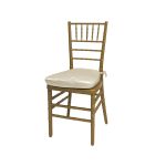 Gold resin Chiavari chair with Ivory cushion seat, spindled high back and slim four-leg frame, elegant event seating