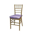 Gold resin Chiavari chair with Lilac cushion seat, spindled high back and slim four-leg frame, elegant event seating