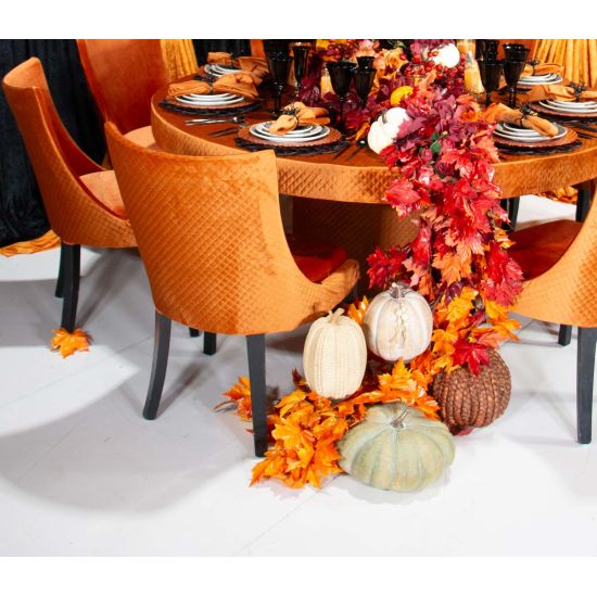 Black-leg Isabello chair with orange velvet cushioned seat and tall modern backrest, premium event dining seating