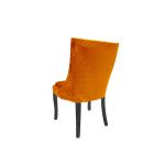 Black-leg Isabello chair with orange velvet cushioned seat and tall modern backrest, premium event dining seating
