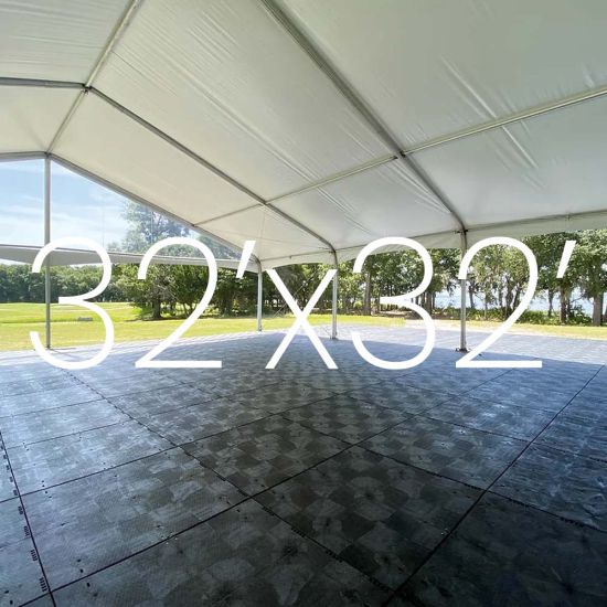Black Duratrack subfloor under tent with 32x32 size overlay text, modular 4x4 panels used as heavy-duty outdoor event floor base.