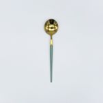Gold dinner spoon with light green handle, stylish flatware for catered events, weddings, and polished tablescapes.