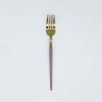 Gold dinner fork with rose gold handle, modern flatware for weddings, receptions, and upscale event table settings.