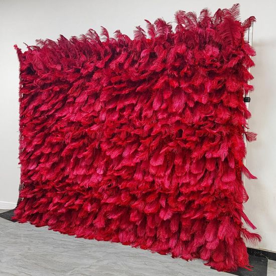 Deep red feather-style plume wall backdrop with layered texture, dramatic photo backdrop panel for luxury weddings and event staging.