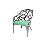 Silver reflective Butterfly Reflection armchair with circular cutout backrest and mint cushioned seat, modern event lounge chair rental
