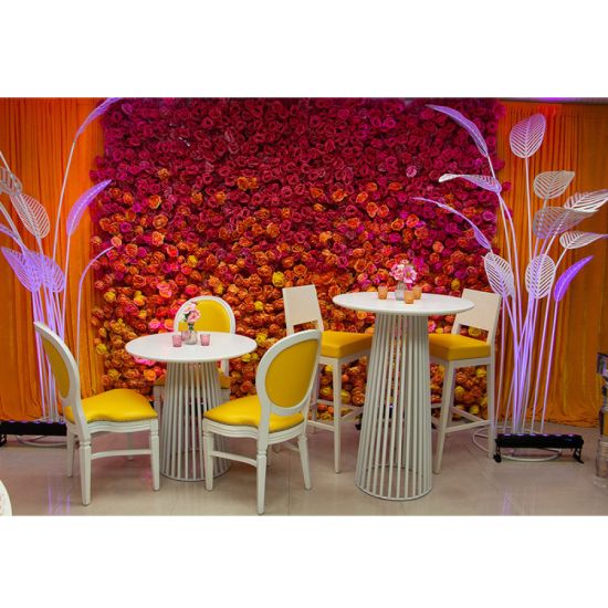 White Bohemian cocktail table with minimalist round top and light wood base for relaxed event lounge décor