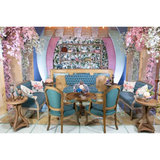 Vintage Jenny loveseat with dusty blue tufted upholstery and distressed wood legs, elegant seating for weddings, lounges, and events.