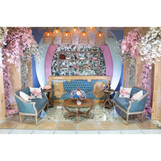 Vintage Jenny loveseat with dusty blue tufted upholstery and distressed wood legs, elegant seating for weddings, lounges, and events.