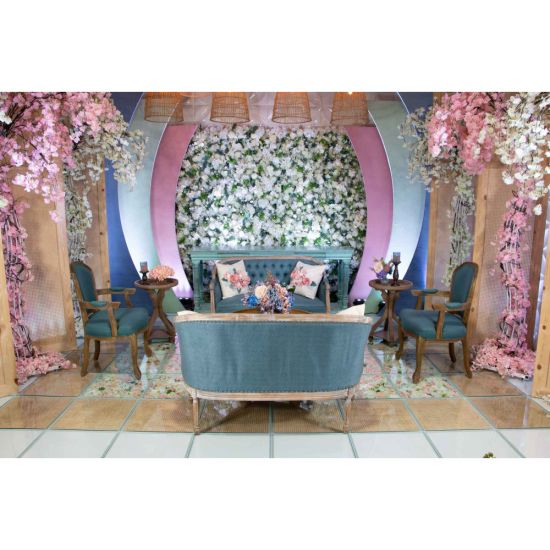 Vintage Faye loveseat with distressed wood frame and tufted dusty blue upholstery, elegant lounge seating for weddings and events.