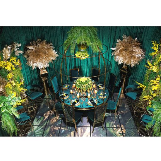 Gold stainless-steel Gem-frame end table with diamond-inspired geometry and glass top, ideal for luxury modern event lounge décor