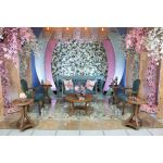 Vintage Faye loveseat with distressed wood frame and tufted dusty blue upholstery, elegant lounge seating for weddings and events.
