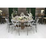 Silver metal cross-back armless banquet chair with white seat cushion