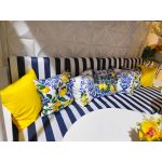 White throw pillow with blue Mediterranean tile pattern and yellow lemon branches, coastal Italian-inspired accent cushion for event lounge décor.