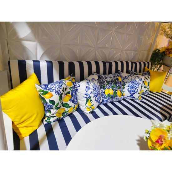 White throw pillow with blue Mediterranean tile pattern and yellow lemon branches, coastal Italian-inspired accent cushion for event lounge décor.