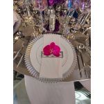 Silver rainbow charger plate with iridescent sheen and ribbed radial texture, shimmering glass charger for weddings and formal events