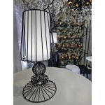 Black wire-frame table lamp with open cage shade and round base, modern accent lighting for event lounge décor and tabletop styling.