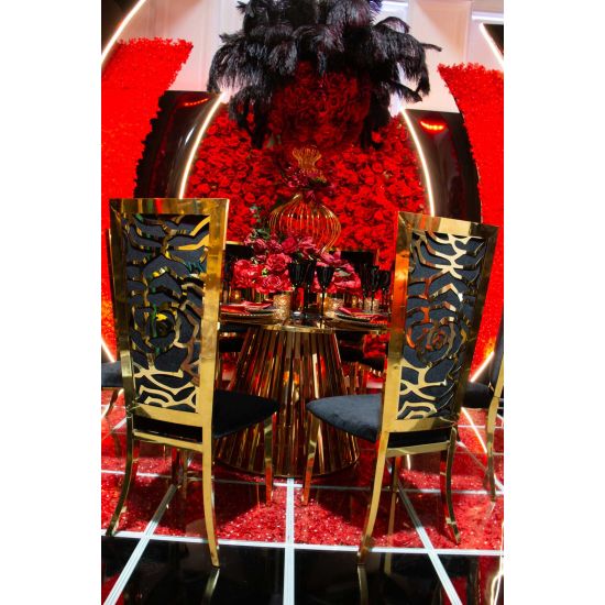 Gold metal “Rosana Chair” event dining chair with sleek gold frame and Red cushion seat, designed for luxury wedding or gala seating.