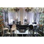 Black ghost resin bar stool with oval tinted backrest, matte black seat and integrated foot-rail, sleek contemporary event bar seating
