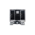 Luxury Portable RestroomBlack portable restroom trailer with dual doors, aluminum steps, diamond plate trim and tow hitch parked outdoors beside a swimming pool