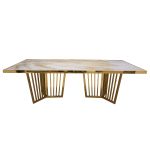 Naples Reflection dining table with gold metal frame and light acrylic top with subtle veining, rectangular surface and sculptural base for events.