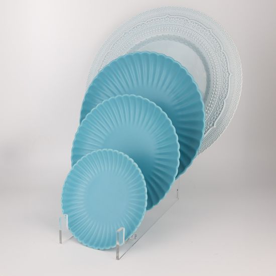 Light blue petal-rim dessert plate with radiating ridges and a smooth center, small round plate on a white background