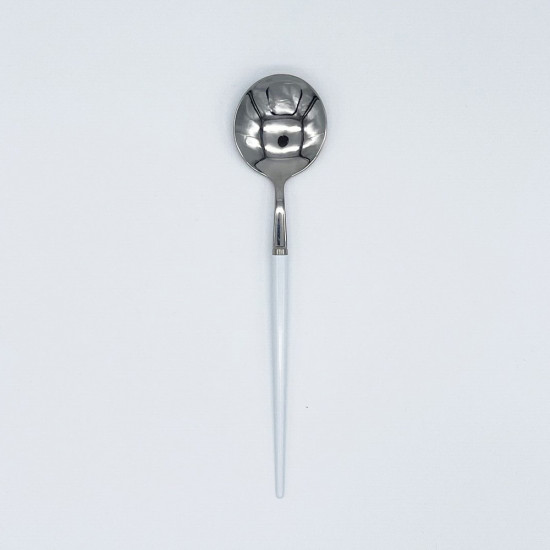 Silver dinner spoon with white handle, stylish flatware for catered events, weddings, and polished tablescapes.