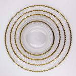 Clear mystique charger plate with smooth center and gold beaded rim, refined glass charger for formal wedding and event table settings