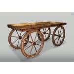 White vintage pull wagon with large spoked wheels, decorative cart for events or displays.