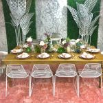 Gold metal palm leaf floor sculpture with multiple leaves, glamorous tropical event décor accent.