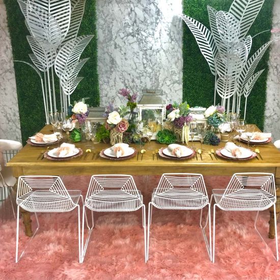 Gold metal palm leaf floor sculpture with multiple leaves, glamorous tropical event décor accent.