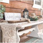 Cream macramé boho table runner with tassels and textured woven pattern, rustic wedding table décor.