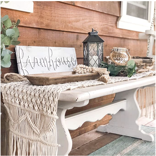 Cream macramé boho table runner with tassels and textured woven pattern, rustic wedding table décor.
