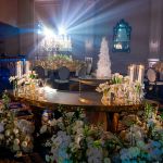 stainless steel serpentine high boy cocktail table with mirrored finish and curving wave-form top for luxury event rental