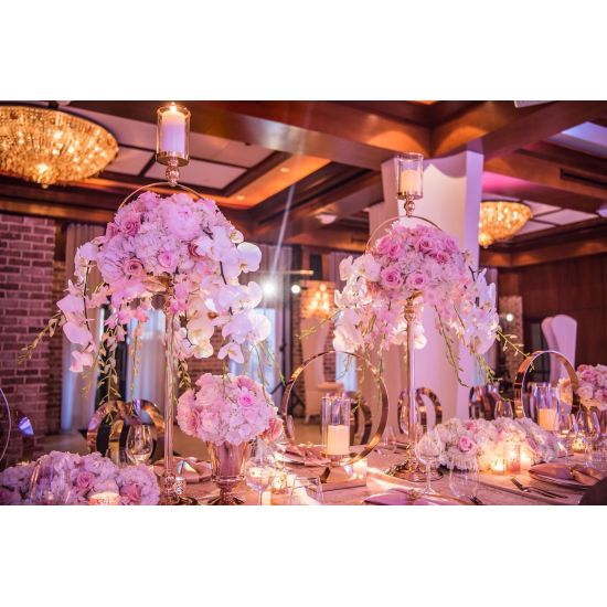 Modern ring candle holder with gold circular frame and clear glass cylinder, minimalist centerpiece décor for weddings and receptions.